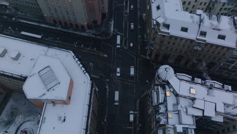 High-angle-view-of-cars-passing-through-intersection-in-city.-Streets-between-snowed-multistorey-buildings.-Berlin,-Germany