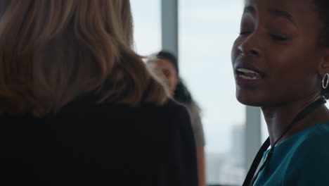 african american business woman chatting to colleague in office brainstorming sharing ideas
