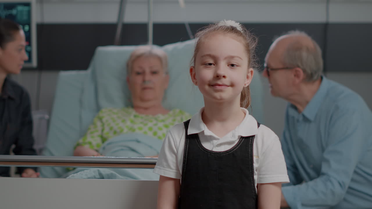Portrait of young child standing in hospital ward at clinic