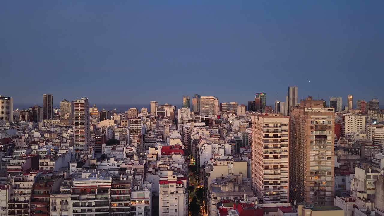 Ascending aerial shot revealing the vast urban landscape of Buenos Aires at sunset