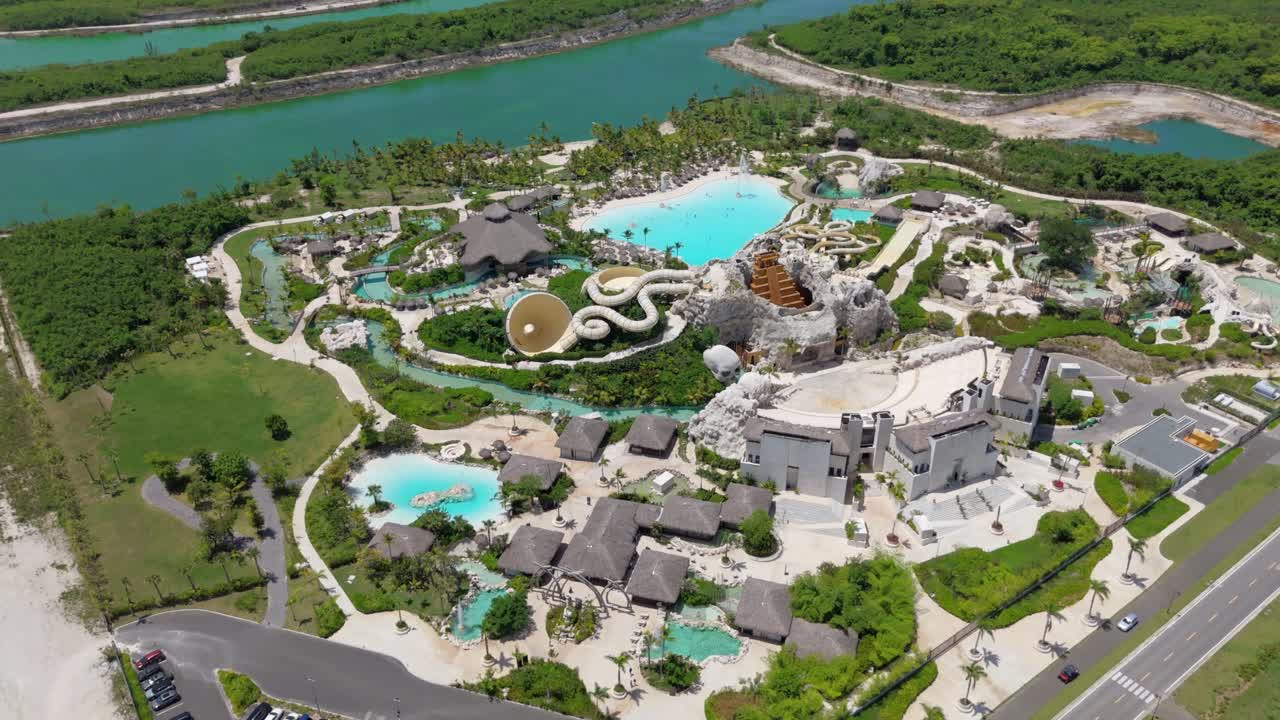 Aerial orbit around amusement water park with slides in the Caribbean