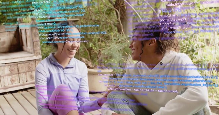 Two women sitting on deck discussing technology while code overlays drifting sparking conversation