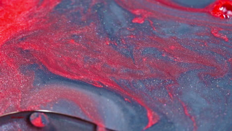 abstract red ink swirling gracefully in blue water, creating a mesmerizing mix of colors