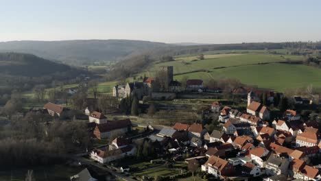 Drone-aerial-view-of-the-fairytale-castle-Adelebsen-on-a-beautiful-autmn-afternoon-in-golden-sunlight