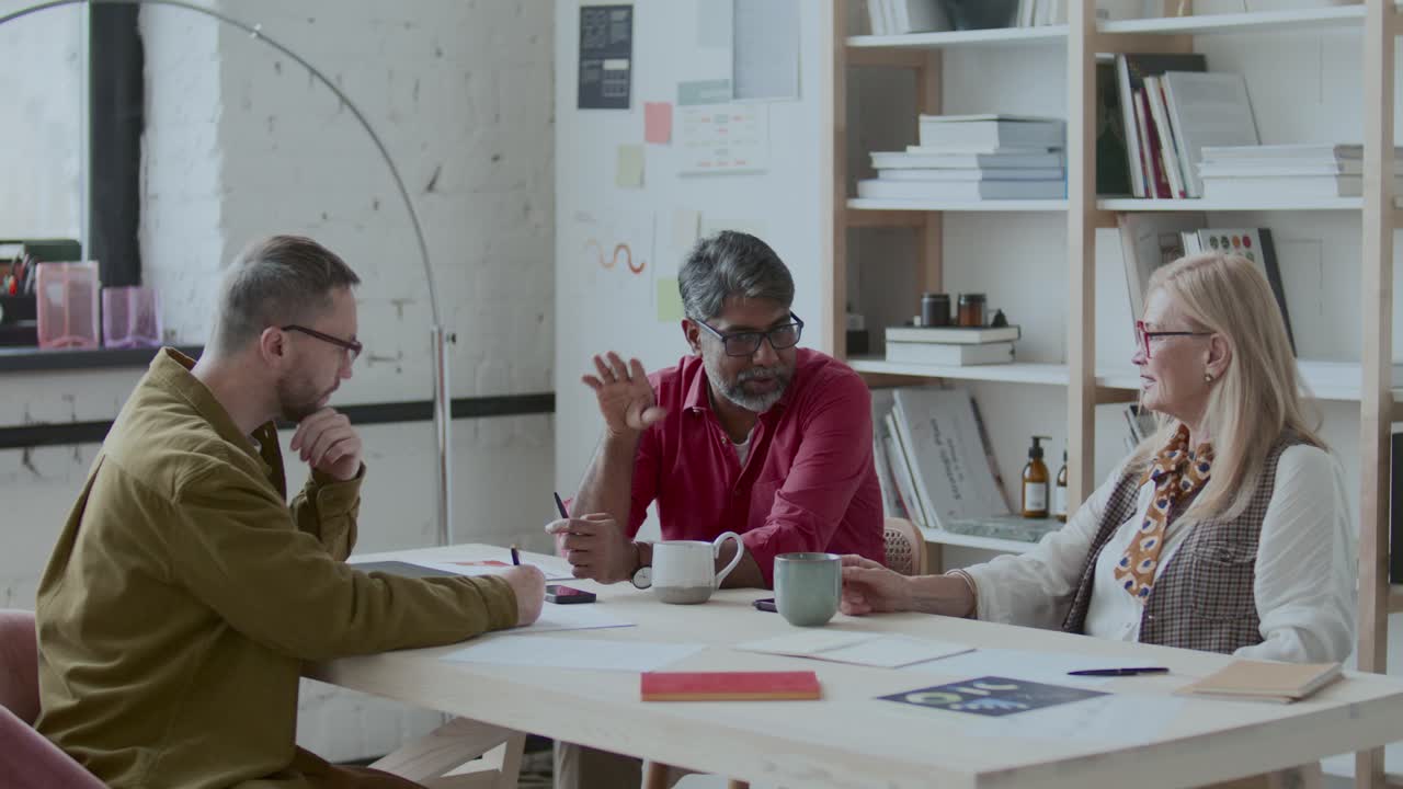 Group of Diverse Business People Discussing Plans at Meeting in Office