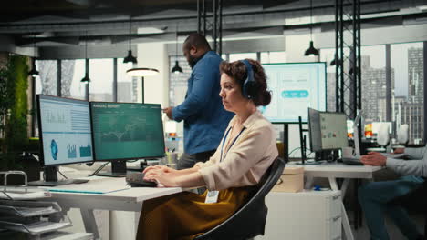 vertical video office administrator uses focus music on headset to solve tasks
