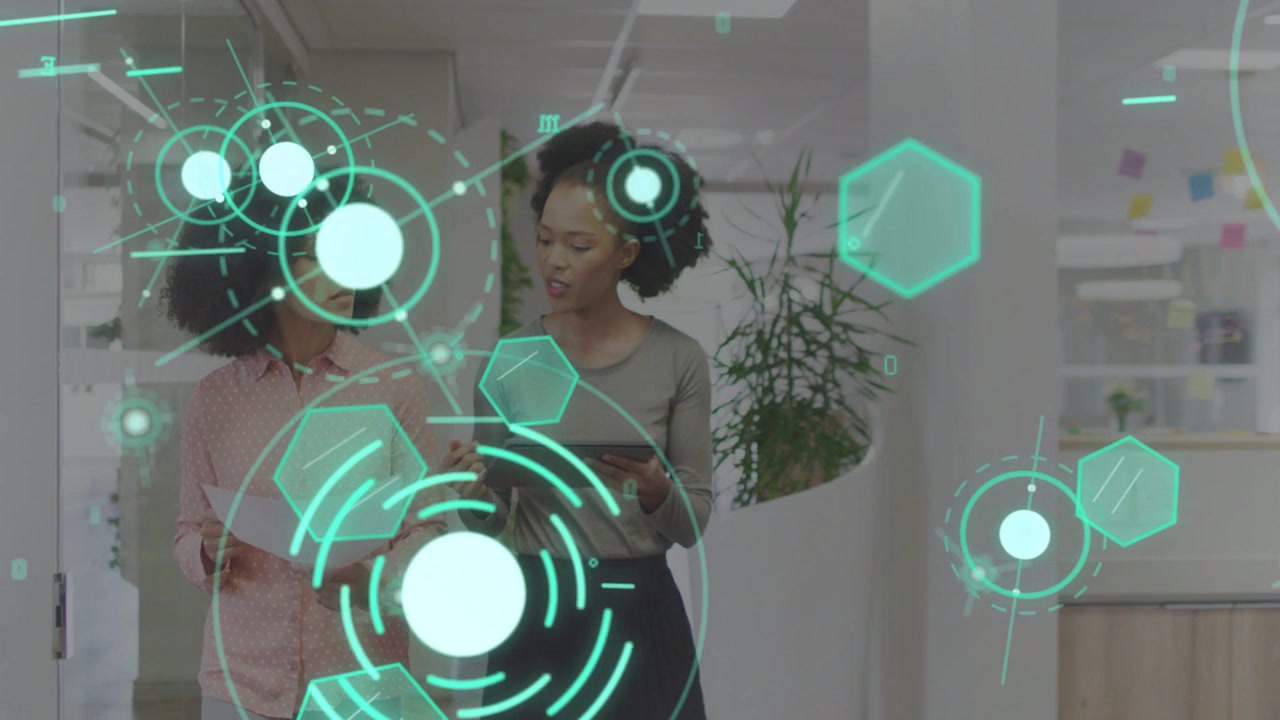 Vertical video: Two women walking office, tapping tablet and activating teal HUD, reviewing docs