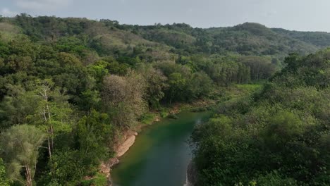 drone passing along sections of the river oyo near the gantung wanagama bridge at the start of the dry season - with matching foliage
