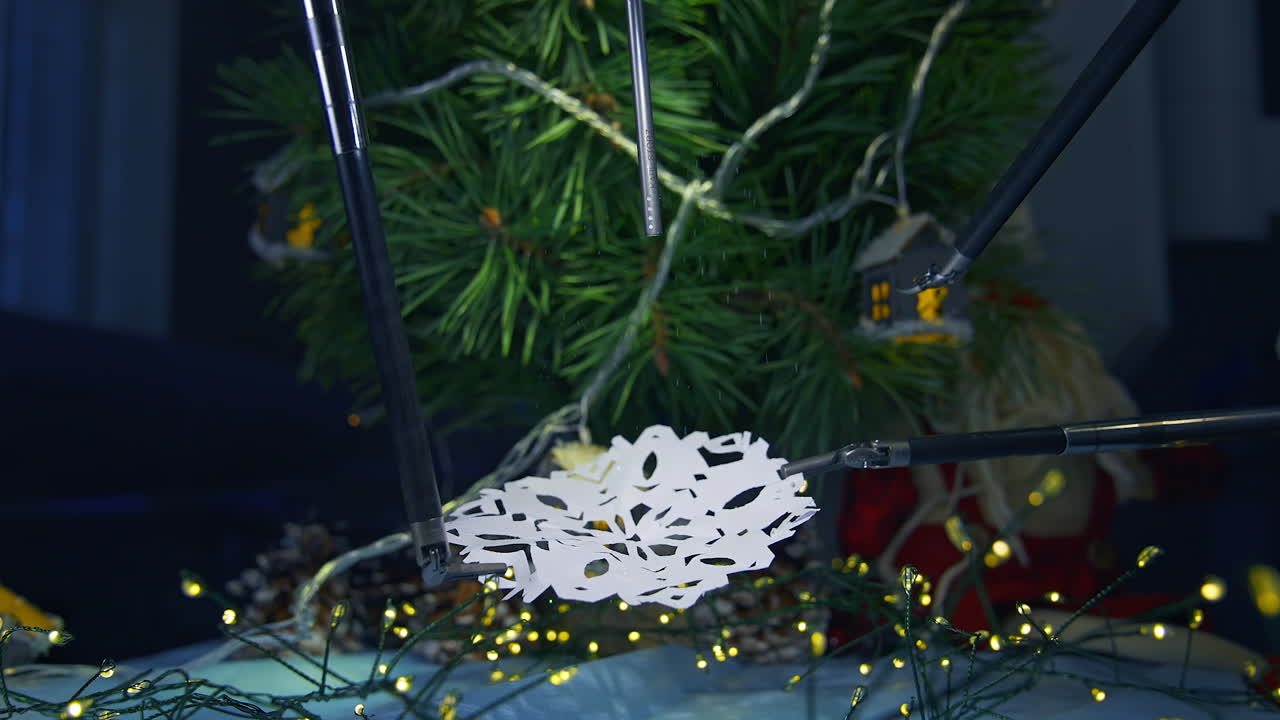 Smart intelligence preparing snowflake from paper while preparing to the Christmas. Cropped view. Future technologies concept