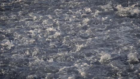 slow motion view of water washing over rocks as it flows back to the sea in tenerife