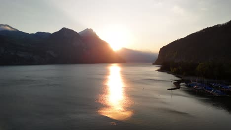 peaceful sunset sunrise golden hour over lake walen walensee water reflection