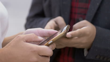 Male-and-female-hands-using-cell-phones