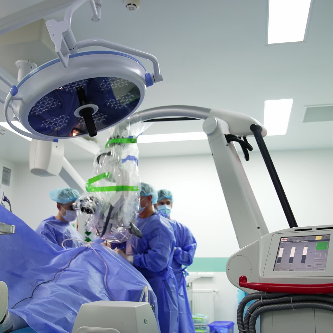 Diverse types of modern equipment in surgery room. Team of surgeon conducting operation at backdrop