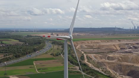 a lone wind turbine near the garzweiler mine, overlooking the highway