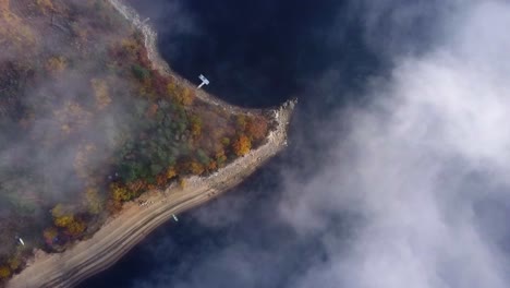 thin cloudscape over a beautiful shoreline - drone going lower