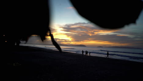 cámara lenta de siluetas caminando por la playa al atardecer en filipinas
