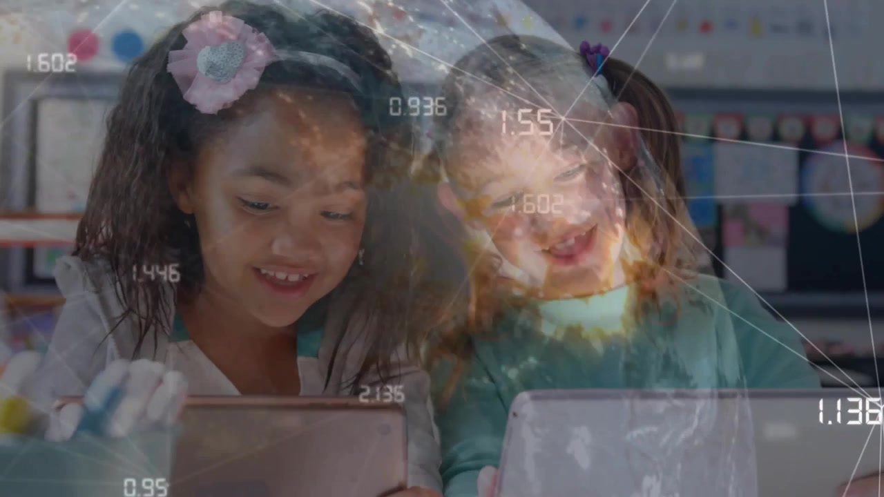 Two girls leaning over tablets glancing starting sharing taps in school globe data overlay rising