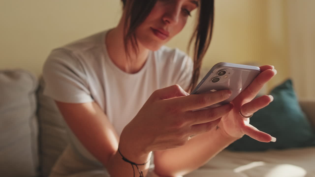 Woman using mobile phone indoors
