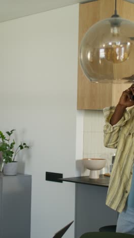 man talking on phone in modern kitchen