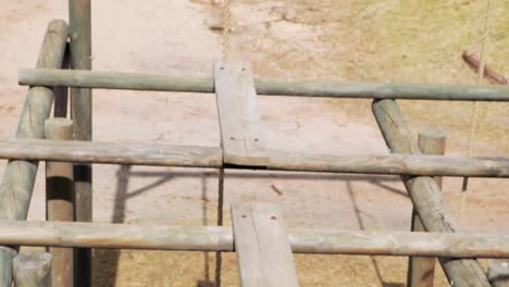 fit man walking over the hurdles during obstacle course