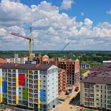 building of a modern district. construction site of new complex with high rise buildings. colorful apartment building in new microdistrict