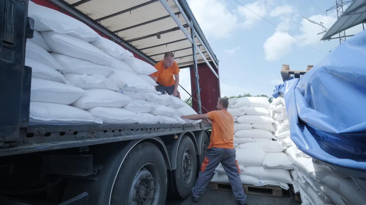 Stacking of bags on truck moving to warehouse