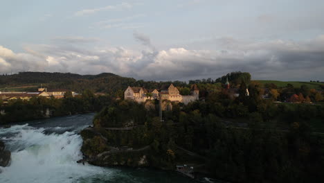 Fantastic-aerial-shot-in-orbit-and-at-a-great-distance-to-the-falls-of-the-Rhine-and-where-the-castle-of-Laufen-can-be-seen