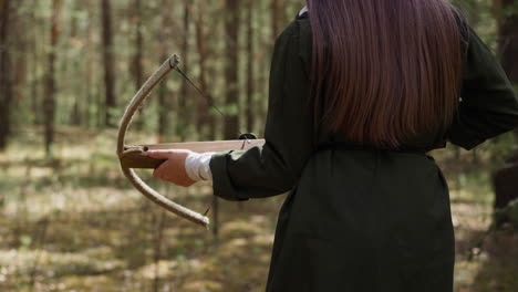 woman in long dress walks in forest