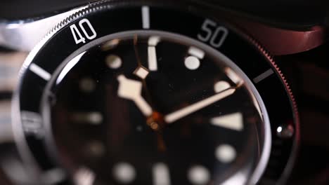 high-end divers watch with second hand movement visible while laying on it's side, shot using a macro lens