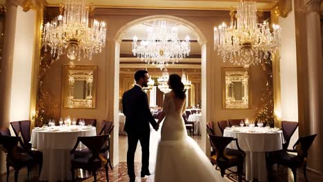 a beautiful bride and groom pose for wedding photos in a luxurious venue