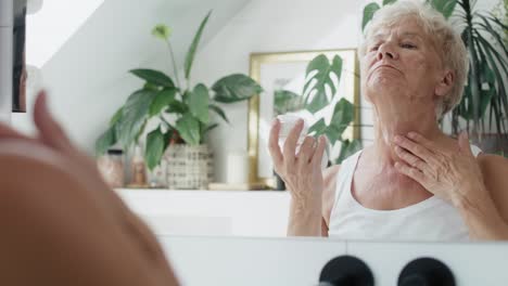 Senior-woman-about-to-apply-a-face-cream