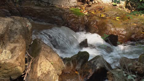 Close-up-detail:-Narrow-mountain-stream-flows-over-rock-pourover