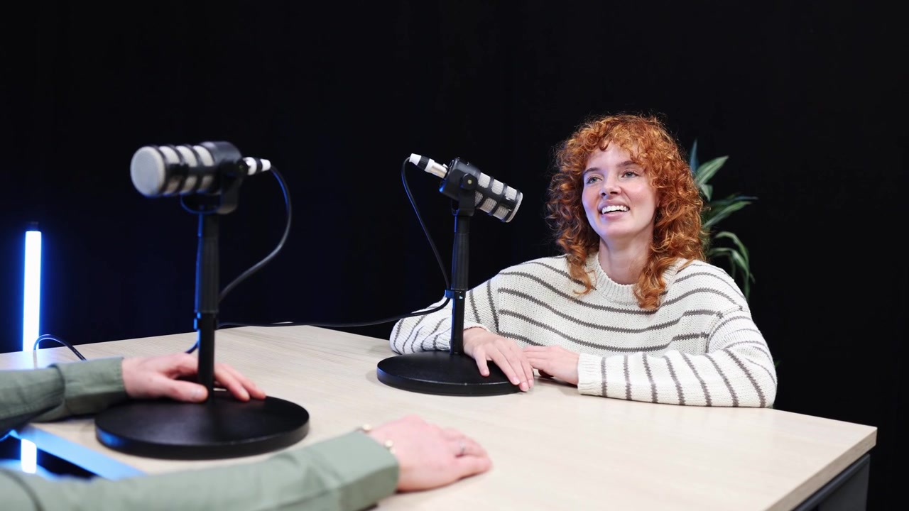 Happy Man and Woman Recording a Podcast in a Modern Studio
