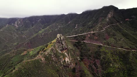 Aerial-view-of-volcanic-mountain-top-road-in-green-landscape,-Tenerife