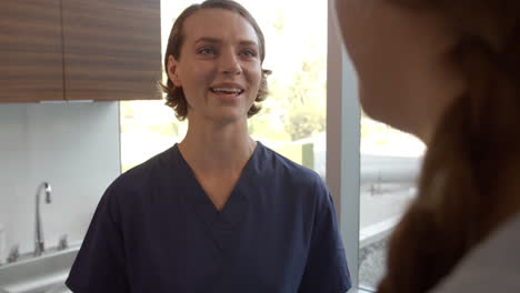 doctor meets with teenage patient in examination room