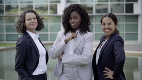 Cheerful-businesswomen-wearing-formal-wear-looking-at-camera