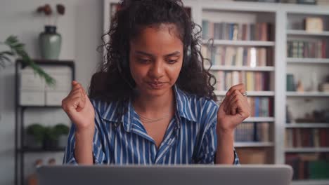 young indian woman in wired headset is nervous during work sits in office