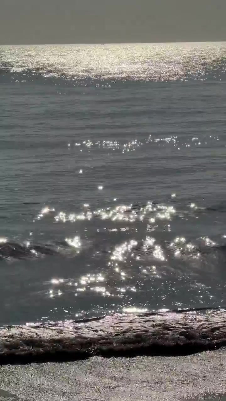 Sparkling Sunlight Glitters on Calm Ocean Waves