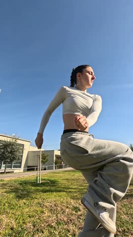 young woman performing modern dance outdoors