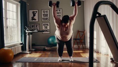 plus-size woman working out with dumbbells at home