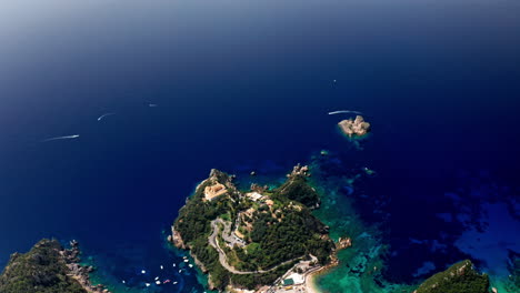 aerial drone shot over the picturesque rocky coastline of paleokastritsa bay in corfu, greece