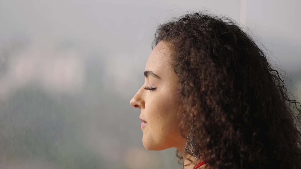 Portrait of a Serene and Smiling Woman with Curly Hair