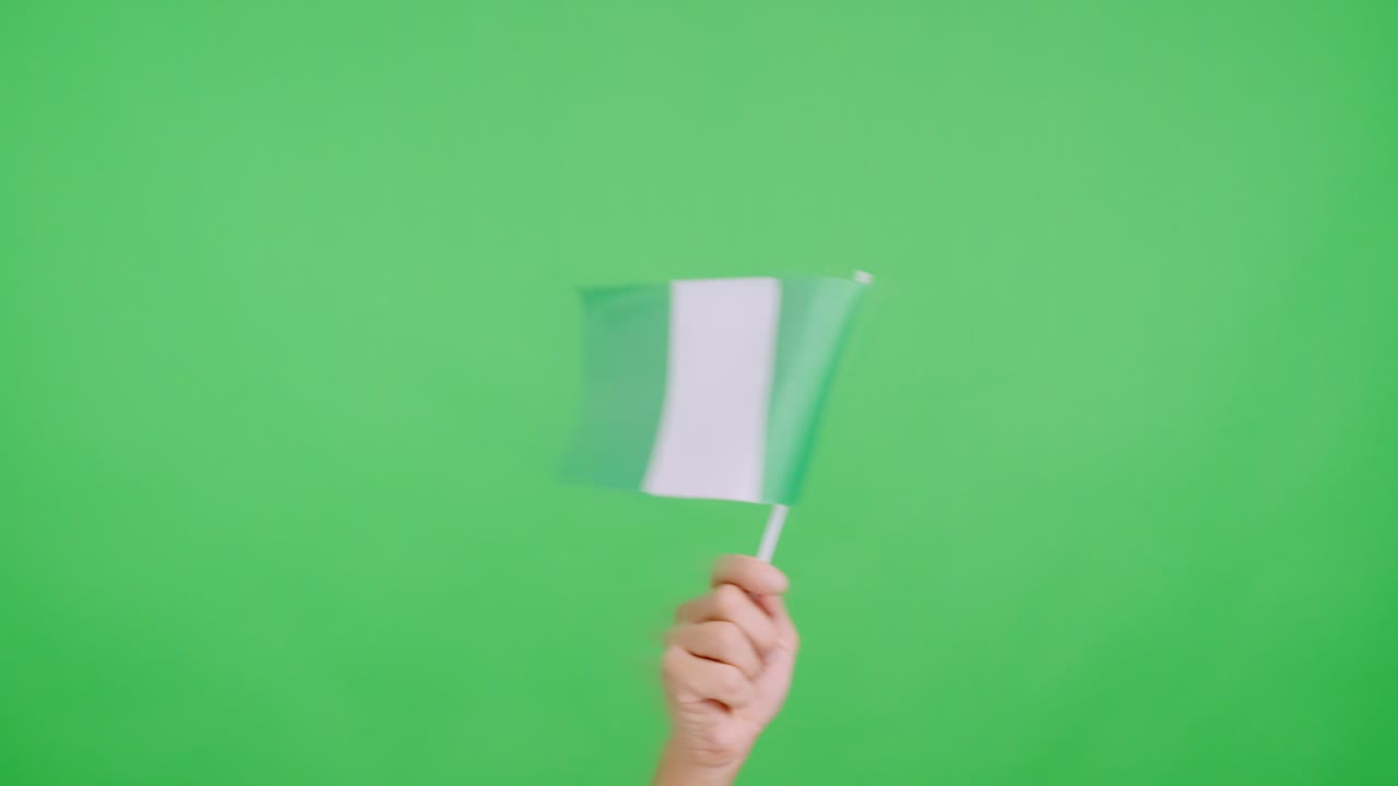 Hand waving a pennant of a nigerian national flag