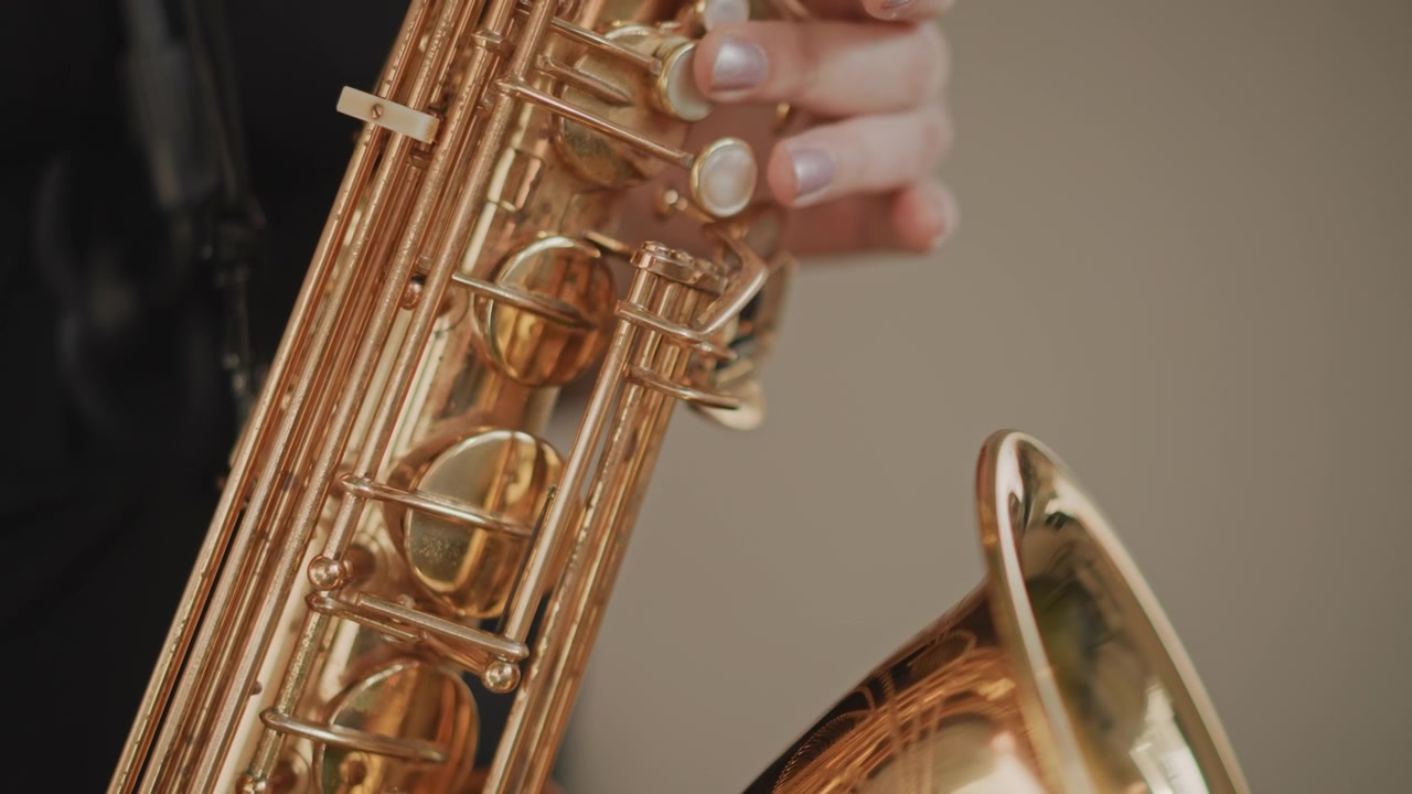 Closeup saxophone keys and fingers studio demonstration of precise fingering and tone control, professional musician showing articulation and breath technique under cinematic lighting, neutral
