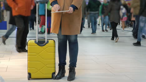 Woman-passing-time-with-pad-at-the-airport