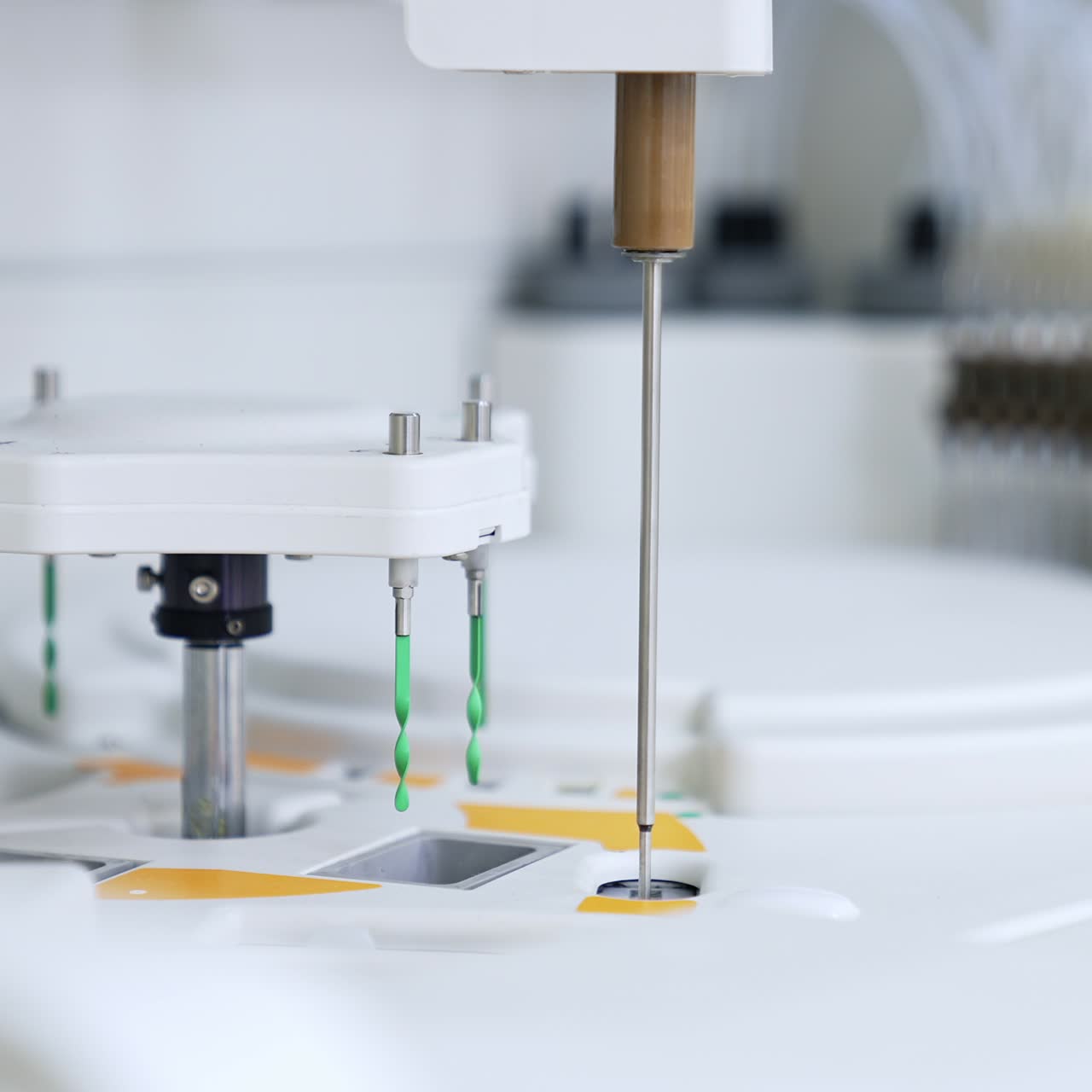 Long metal needle moving from one slot to another. Advanced equipment working in the science laboratory for blood test