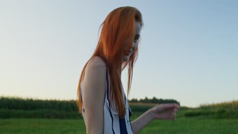 young woman in a field at sunset