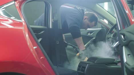 professional car cleaning. сar wash. interior detailing. dry clean and detail a car interior. deep seats cleaning. wiping foam in car wash. cleaning the car panel from dust. a vacuum cleaner