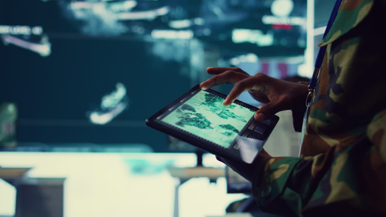 Army soldier reviews targets on satellite world map to ensure global protection
