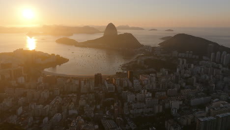 Breite-Luftaufnahmen-Des-Viertels-Botafogo-Mit-Der-Bucht-Und-Dem-Zuckerhut-Im-Hintergrund-Während-Des-Sonnenaufgangs-Und-Rio-De-Janeiro